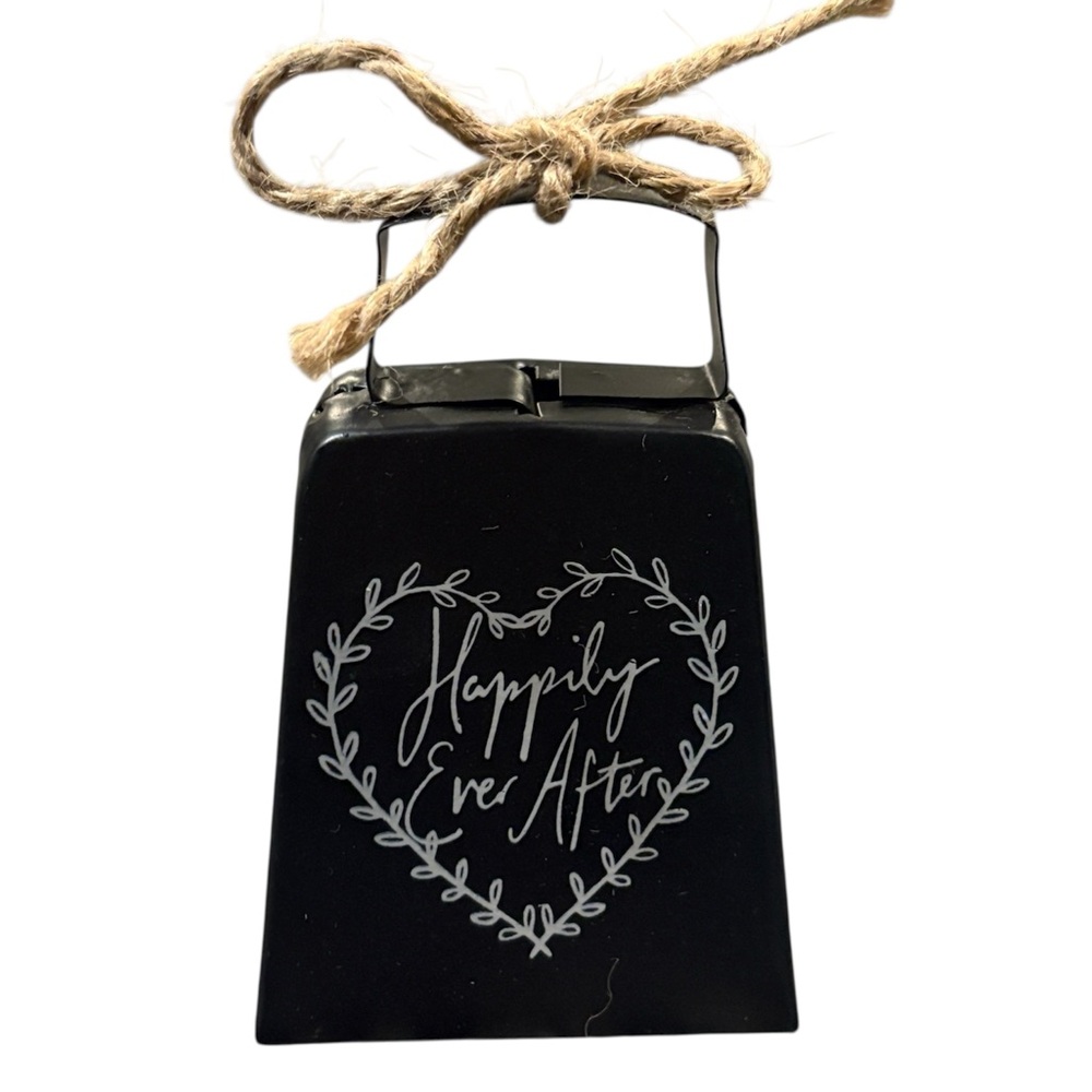 Cowbell with distressed black finish and a natural twine loop for hanging